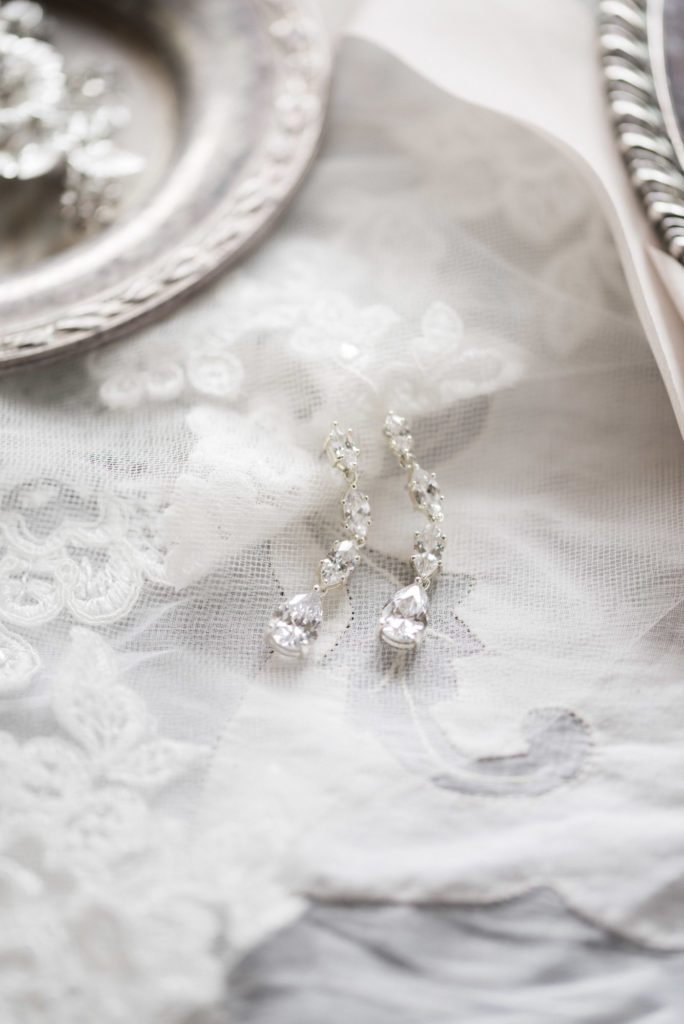 bride's wedding day earrings and veil