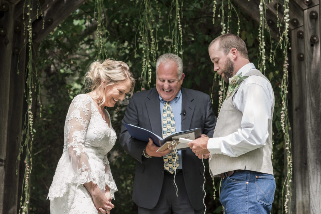 bride and groom reading vows during ceremony