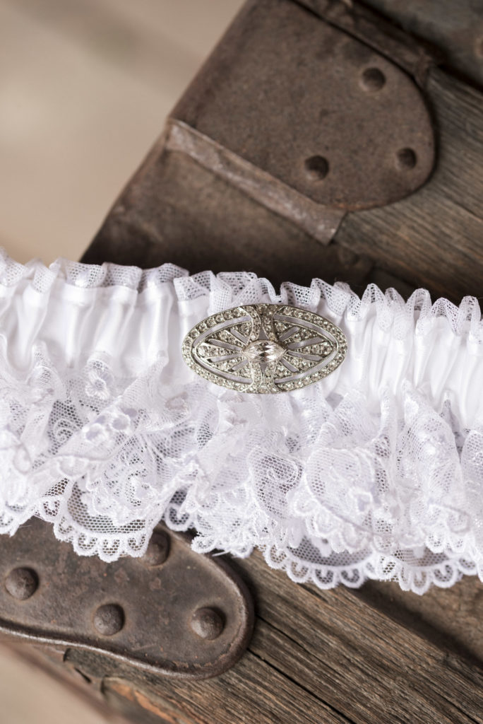 bride's white lace garter with embellishment