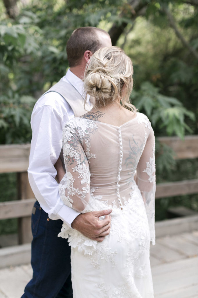 groom holding bride in vintage lace wedding dress
