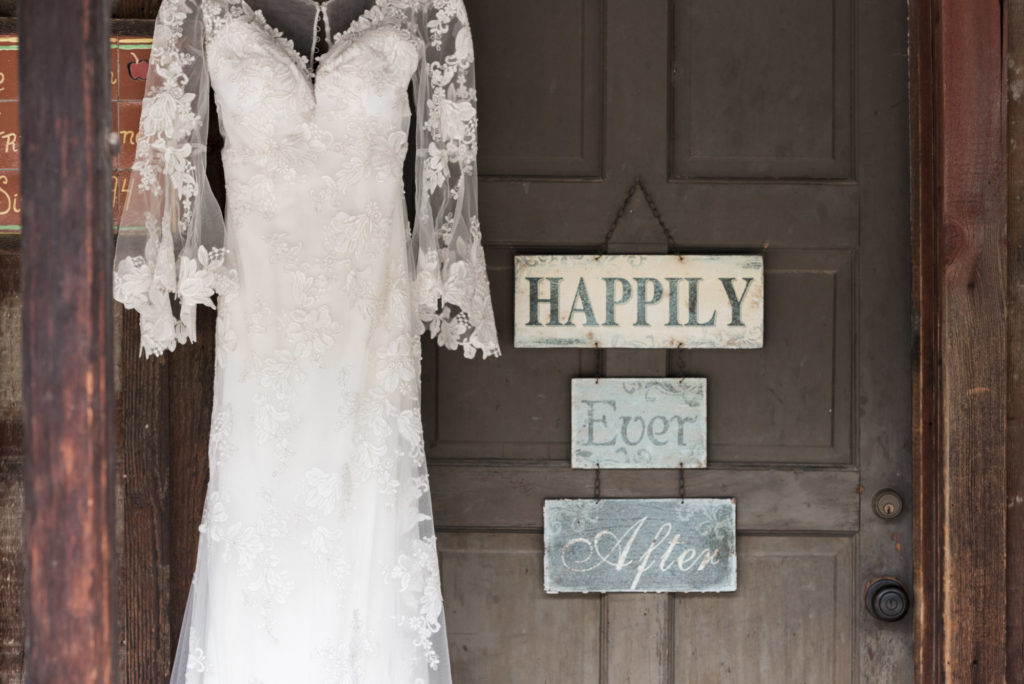 vintage lace wedding dress on rustic barn door
