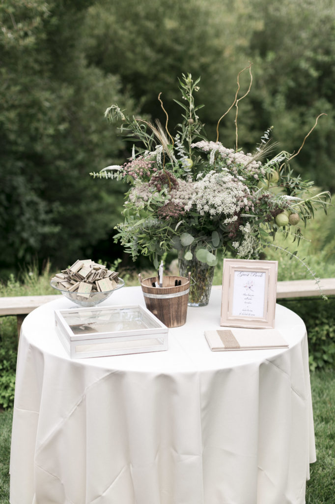 wedding welcome table with bouquet and guest book